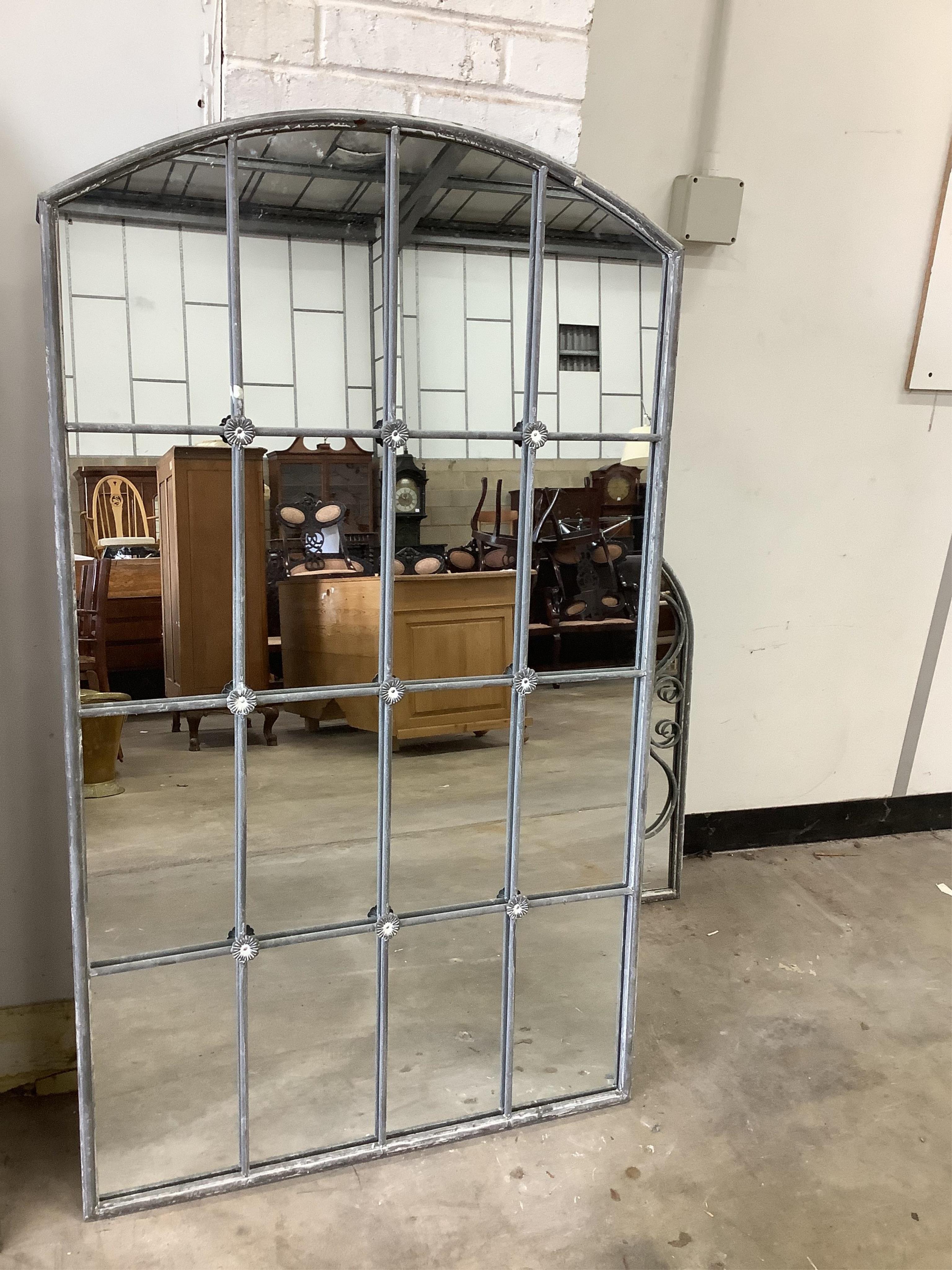 A weathered metal wall mirror, width 80cm, height 138cm. Condition - good